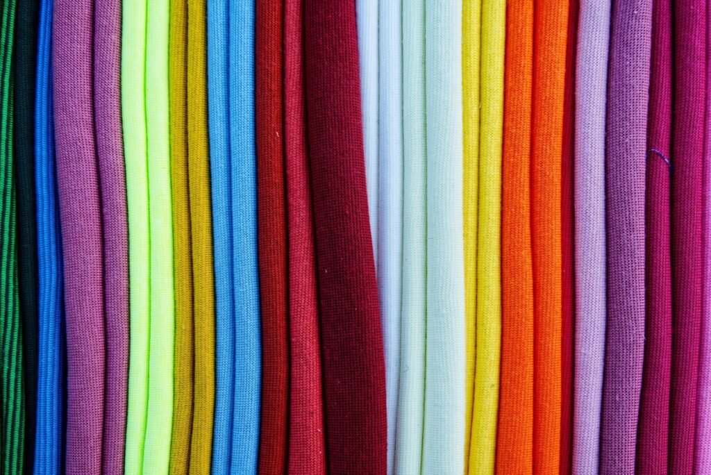Vibrant fabric swatches creating a rich, textured background. Ideal for design, fashion, and crafting themes
