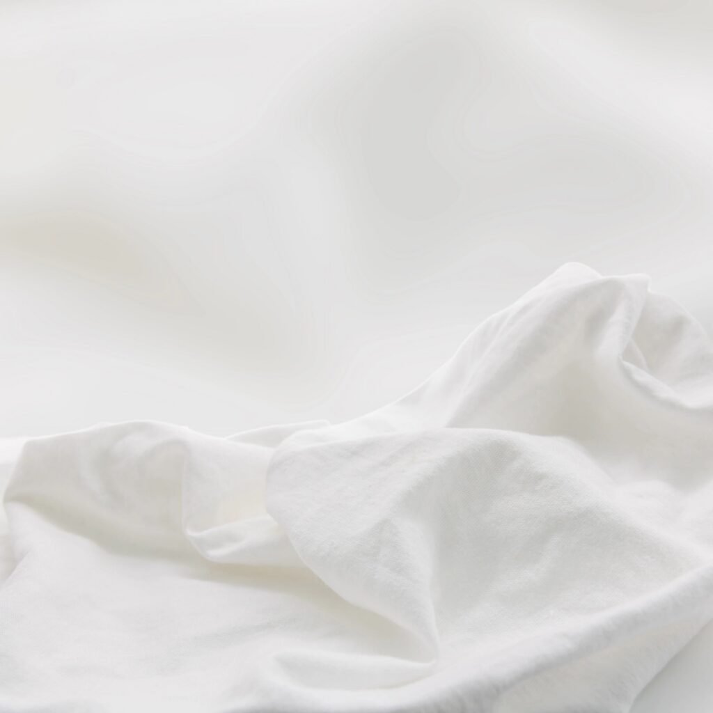 Ivory-gold tissue silk fabric with luminous sheen and soft drape